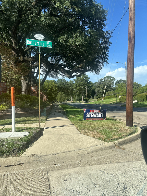 sign for DA Stewart place between sidewalk and street