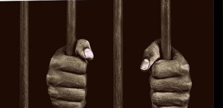 hands gripping cell bars