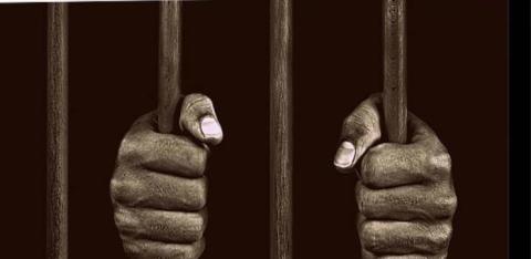 hands gripping cell bars